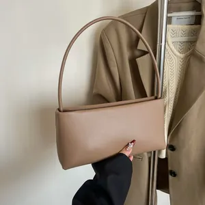 Minimalist brown leather baguette shoulder bag shown with beige blazer aesthetic