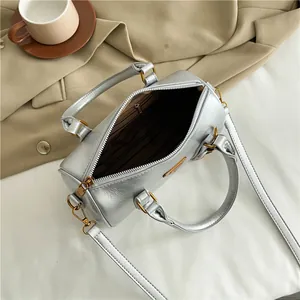 Silver retro bowling bag with metallic pleated texture and top handle for women