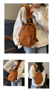 Detail der orangefarbenen Nylon-Brusttasche mit Reißverschlussfächern und breitem Gurt