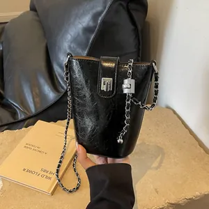 Chic black bucket bag with vintage pleated leather and silver chain strap for women