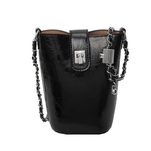 Glossy black bucket bag with silver chain and wrinkled patent leather texture