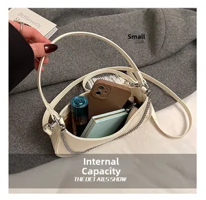 Internal capacity of off-white crescent underarm bag with phone and cosmetics