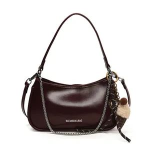 Glossy burgundy leather crescent underarm bag with silver chain and cute plush charm