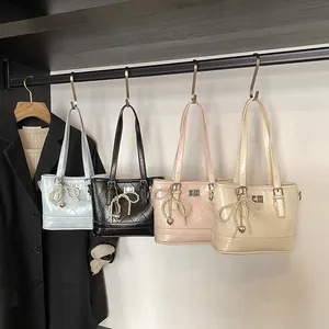 Quilted fashion handbags with pearl bow charms in blue, black, pink, and beige