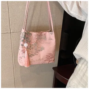 Detail of pink embroidered handbag with traditional Chinese garden pattern and tassel