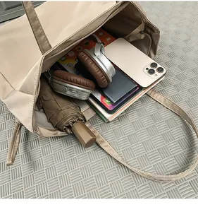 Vista dall'alto della capiente borsa tote in nylon con spazio per libri e cuffie