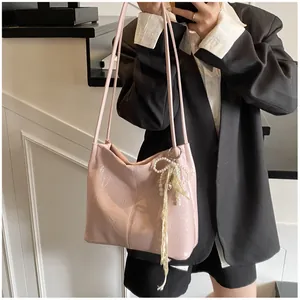 Pink pleated patent leather tote bag styled with black blazer and pearl bow charm