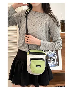 Detailansicht der grün-weißen Umhängetasche im Color-Block-Design mit LUCKY-Label-Patch