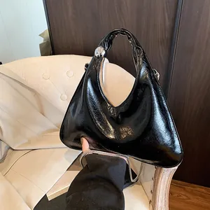 Minimalist black glossy triangle handbag with silver chain strap and metal ball accents