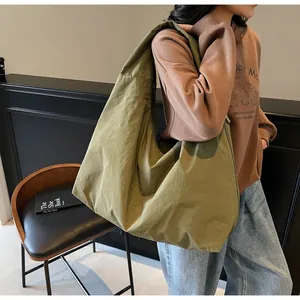 Detail of army green large canvas tote bag showing the texture and shoulder strap fit