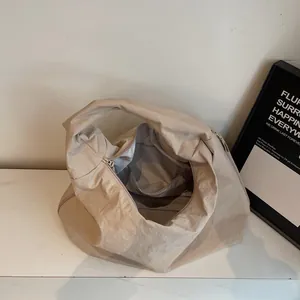Minimalist beige tote bag with a textured finish and large capacity for daily commuting