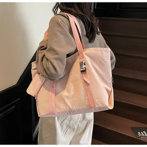 Detail of pink large-capacity tote bag with detachable coin purse and buckle strap