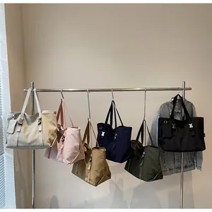 Selection of large nylon tote bags in six colors hanging for a stylish casual look