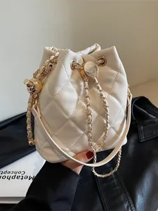 White quilted bucket bag with gold chain strap and drawstring closure for women
