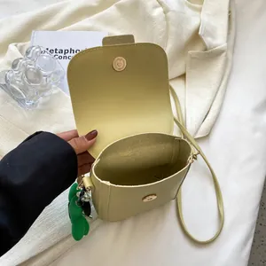 Minimalist lime yellow crossbody bag with magnetic buckle and cute green doll pendant