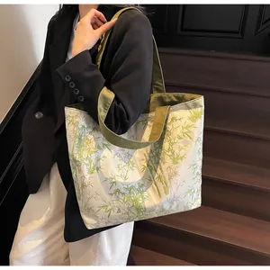 Detail of bamboo print tote bag carried by a model in a sophisticated setting