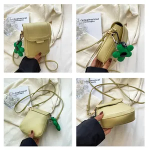 Detailed views of pale yellow minimalist crossbody phone bag with green flower charm