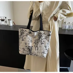 Detailed view of the large tote bag featuring artistic black and white bamboo ink patterns