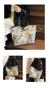 Detail of large canvas tote bag featuring traditional ink bamboo prints and shoulder straps