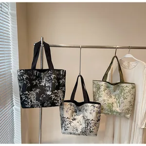 Detail showing high-capacity tote bags with Chinese bamboo patterns in three colors