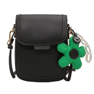 Minimalist black leather phone crossbody bag with green flower charm and chain