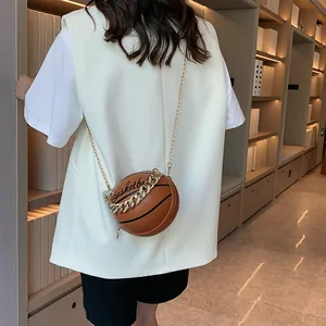 Fashionable basketball-shaped crossbody bag in brown textured leather with gold chain strap