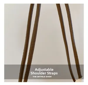 Detailed macro view of adjustable brown faux leather shoulder straps with neat stitching