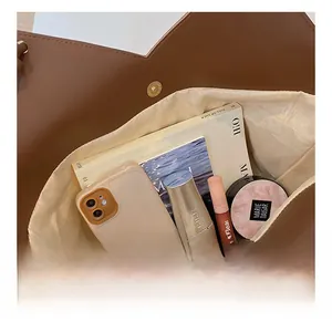 Interior view of large capacity tote bag showing spacious room for books and makeup