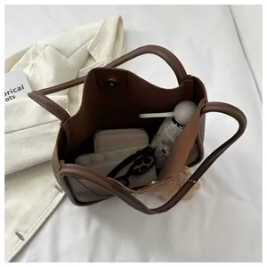 Spacious dark brown tote bag showing internal storage for phone, wallet and umbrella