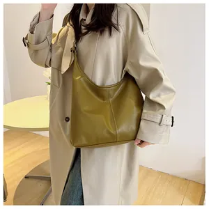 Olive green hobo bag featuring matte leather texture and vertical stitch detailing