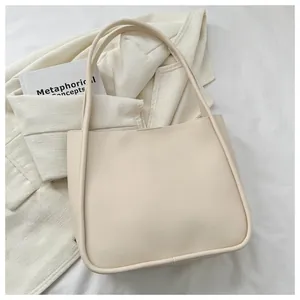 Detailed close-up of cream PU leather tote bag with elegant shoulder strap and clean stitching