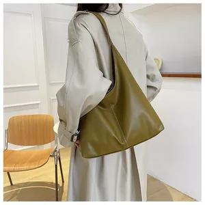 Olive green hobo tote bag shown on model featuring textured PU leather and wide shoulder strap