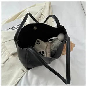 Interior view of large black PU tote bag showing capacity for phone, wallet and umbrella