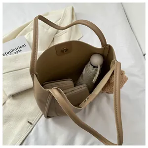 Top view of large khaki tote bag showing spacious interior with daily essentials and cute charm