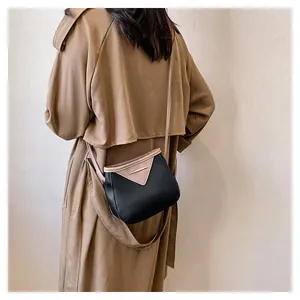 Rear view of a model wearing a retro color-block crossbody bag over a beige coat