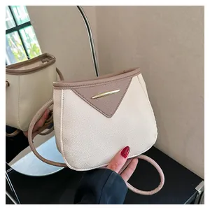 Detail of retro color-block crossbody bag with lychee grain texture and metal bar buckle