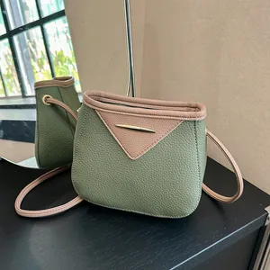 Vintage olive green and brown leather crossbody bag with pebble texture and gold bar