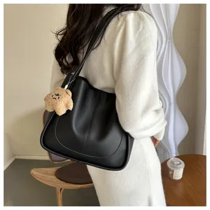 Chic black matte PU leather tote bag with stylish U-stitch detail and cute bear charm