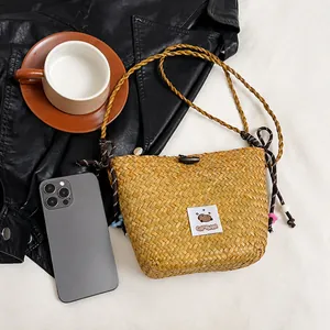 Mini straw bucket bag with Capybara patch, wooden buckle and woven shoulder strap details