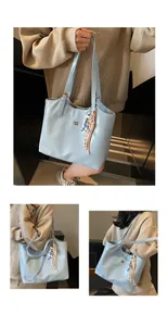 Detailed views of light blue glossy tote bag with gold logo and colorful tassel charm