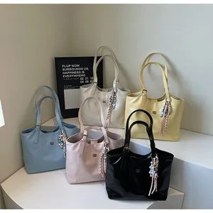 Detailed collection of shiny tote bags in five pastel colors with cute charms and metal logos