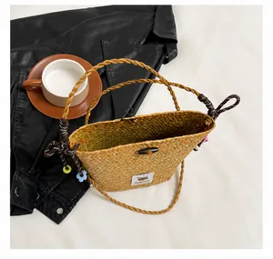 Top view of handmade straw bucket bag showing spacious interior and wooden button closure