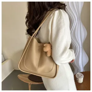 Shoulder tote bag in khaki PU leather with brown plush bear charm detail