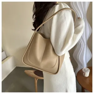Modern minimalist oatmeal PU leather tote bag shown on model in a stylish interior