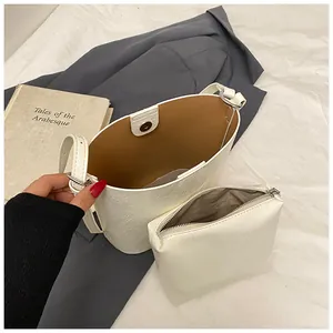 Minimalist white leather bucket bag with large capacity and removable inner pouch