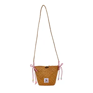 Minimalist straw woven bucket bag for women featuring colorful ropes and capybara patch