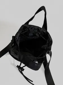Top view of bucket bag showing drawstring closure, spacious interior and zip pocket