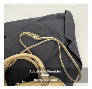 Detail showing the adjustable leather shoulder strap with silver buckle on the Boston bag
