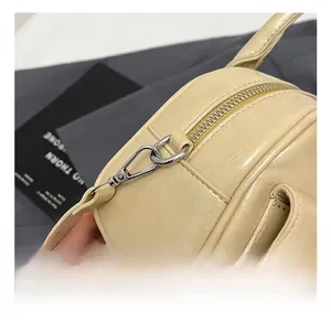 Detail showing silver metal hooks and premium leather texture of the Boston bag