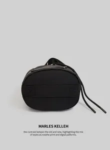 Close-up of a black bucket bag reinforced base with cross-stitch durable fabric detail